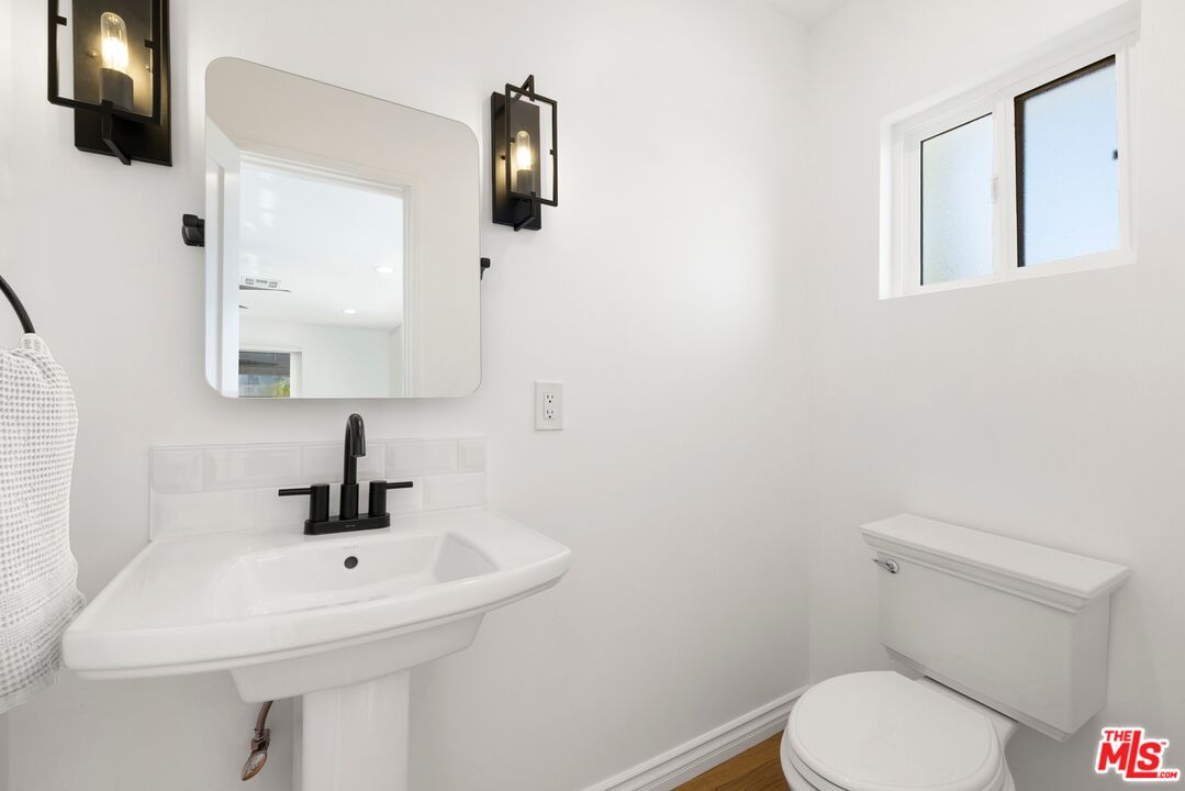1788 North Orange Grove Avenue Los Angeles, CA 90046 - Photo 15 of 20 a bathroom with a toilet sink and mirror