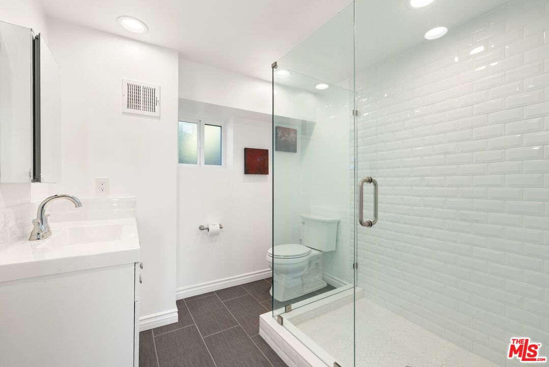 1788 North Orange Grove Avenue Los Angeles, CA 90046 - Photo 17 of 20 a bathroom with a sink toilet and shower