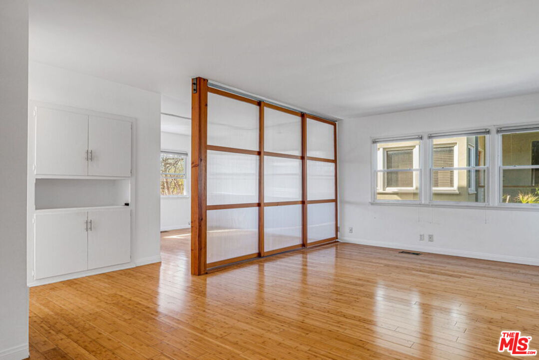 219 3rd Avenue, Unit 1/2 Venice, CA 90291 - Photo 4 of 13 a view of an empty room with window and wooden floor