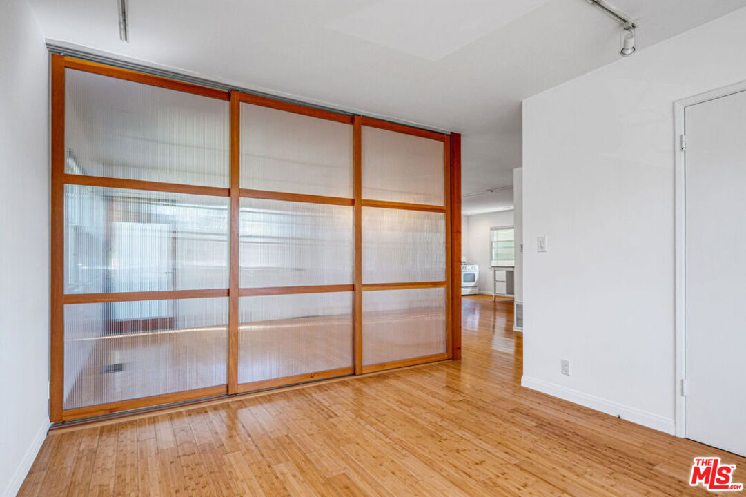 219 3rd Avenue, Unit 1/2 Venice, CA 90291 - Photo 8 of 13 a view of an empty room with wooden floor and a window