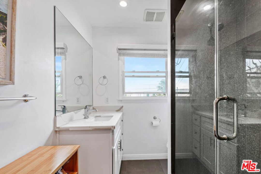 219 3rd Avenue, Unit 1/2 Venice, CA 90291 - Photo 10 of 13 a bathroom with a shower a mirror and a sink