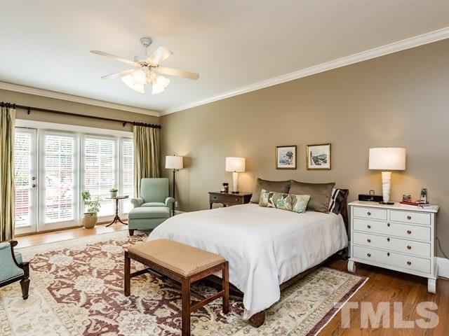 807 Harvey Street Raleigh, NC 27608 - Photo 11 of 24 a bedroom with a bed and wooden floor