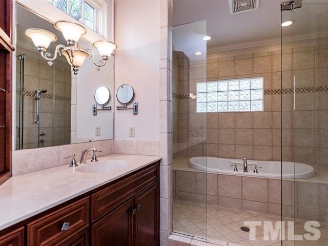 807 Harvey Street Raleigh, NC 27608 - Photo 12 of 24 a bathroom with a sink a toilet a mirror and shower