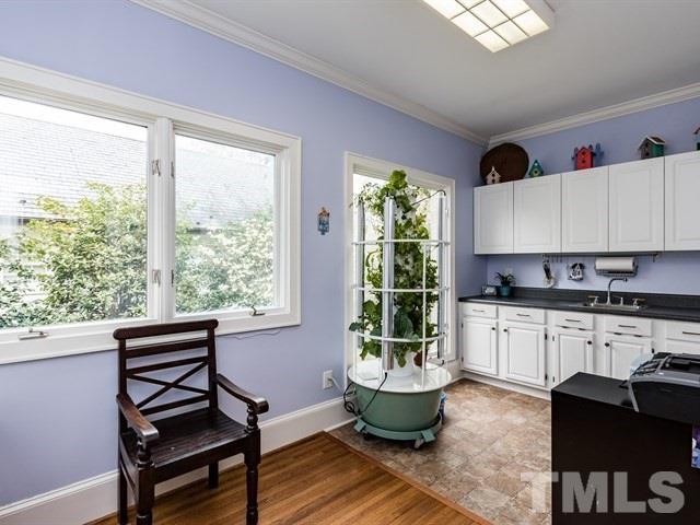 807 Harvey Street Raleigh, NC 27608 - Photo 13 of 24 a kitchen with a stove a sink and cabinets