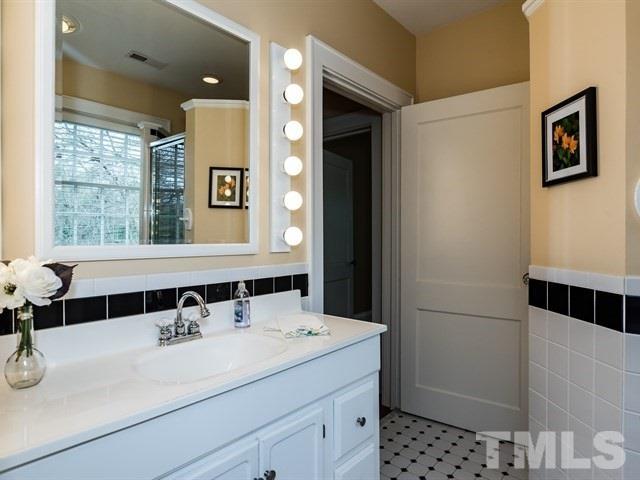 807 Harvey Street Raleigh, NC 27608 - Photo 18 of 24 a bathroom with a sink and a mirror