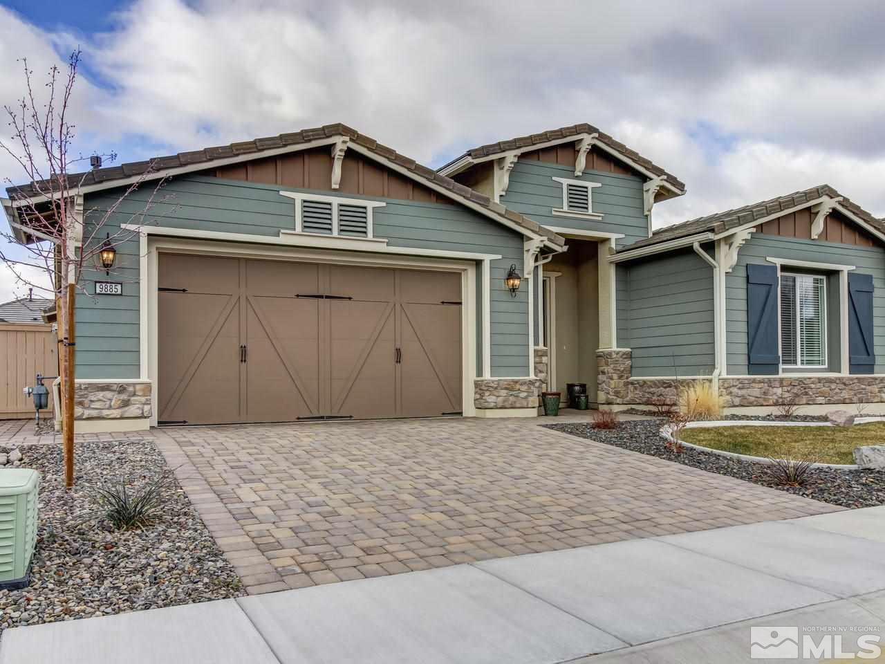 9885 Shadowless Trail Reno, NV 89521 - Photo 1 of 25 a front view of a house with a yard and garage