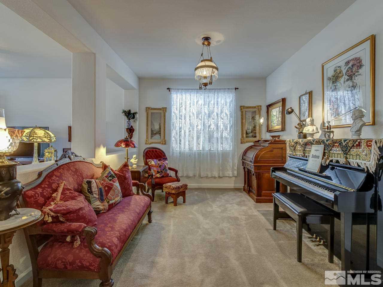 9885 Shadowless Trail Reno, NV 89521 - Photo 14 of 25 a living room with furniture a dining table and a piano table