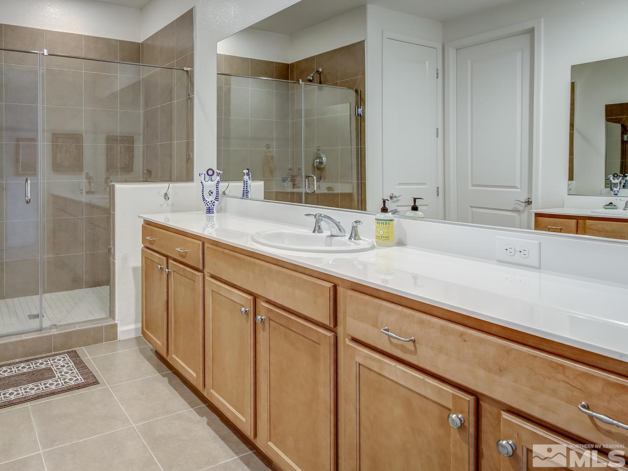 9885 Shadowless Trail Reno, NV 89521 - Photo 17 of 25 a bathroom with a sink and a mirror