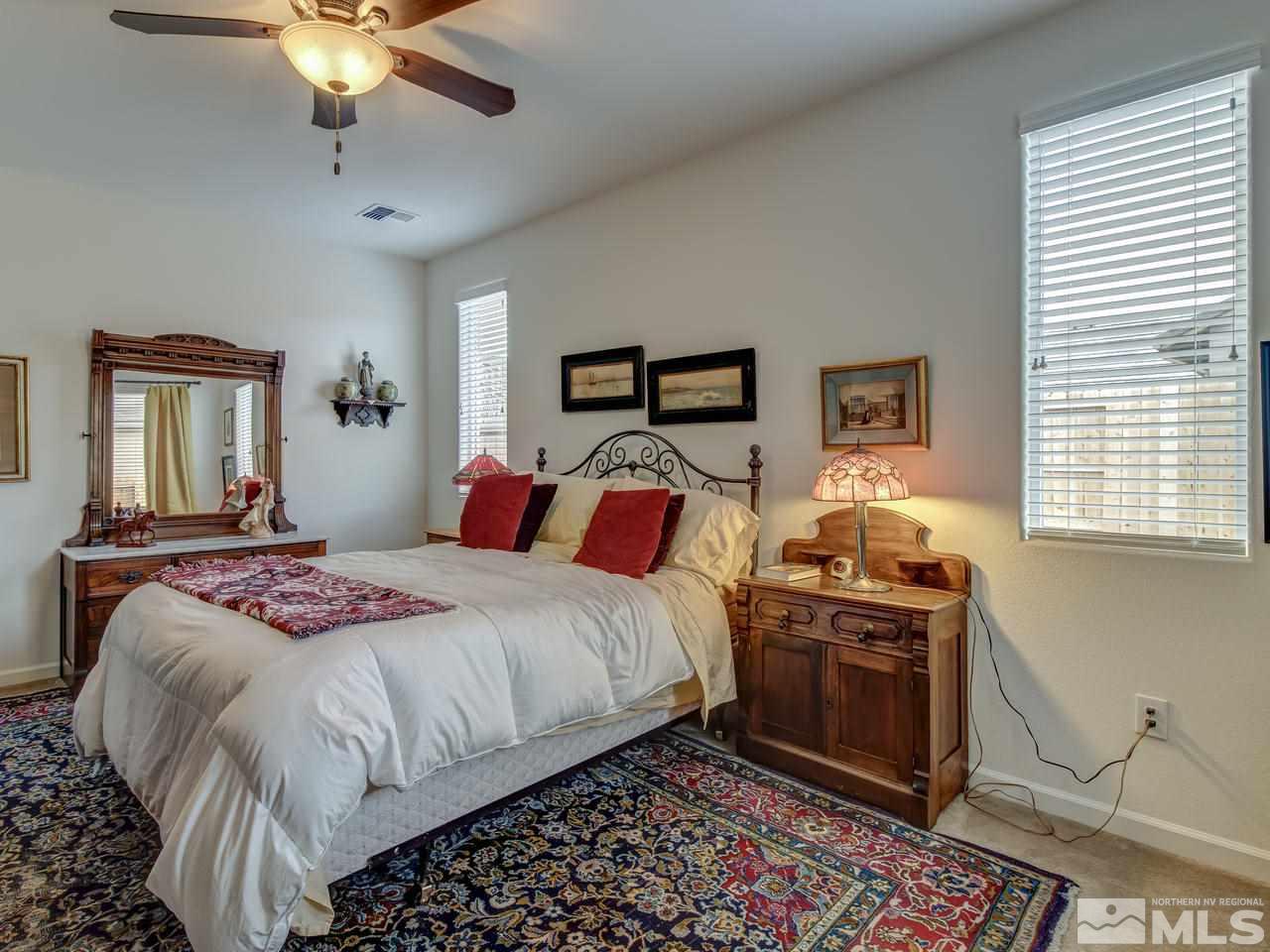 9885 Shadowless Trail Reno, NV 89521 - Photo 19 of 25 a bedroom with a bed and a chandelier