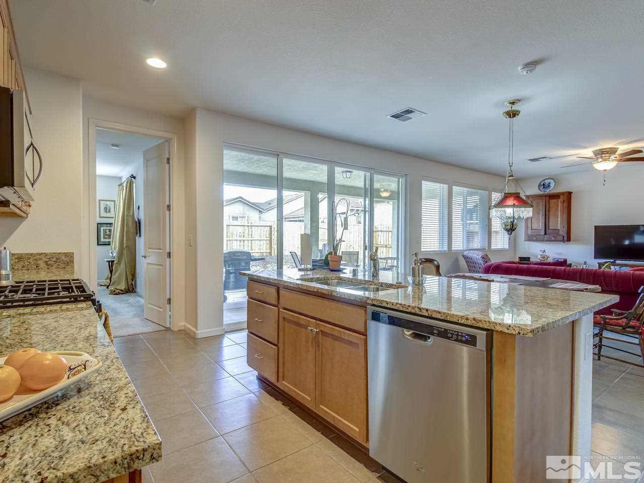 9885 Shadowless Trail Reno, NV 89521 - Photo 5 of 25 a kitchen with counter top space and stainless steel appliances