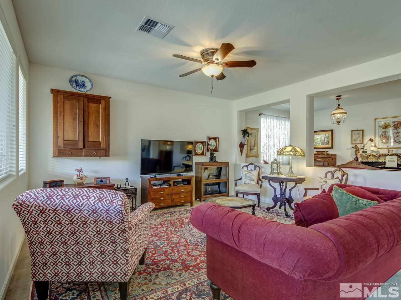 9885 Shadowless Trail Reno, NV 89521 - Photo 7 of 25 a living room with furniture and a flat screen tv