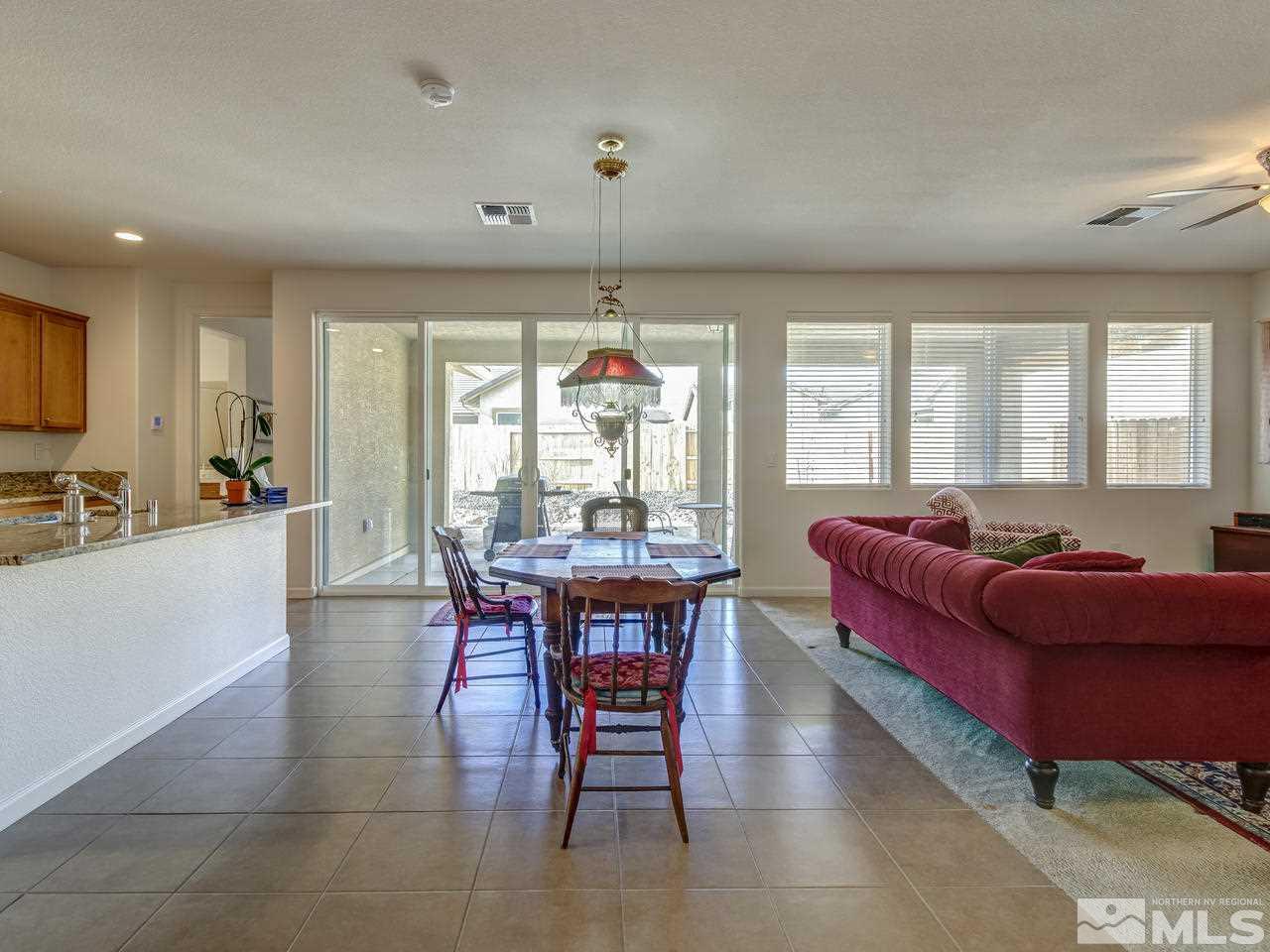 9885 Shadowless Trail Reno, NV 89521 - Photo 8 of 25 a living room with furniture a table and a large window
