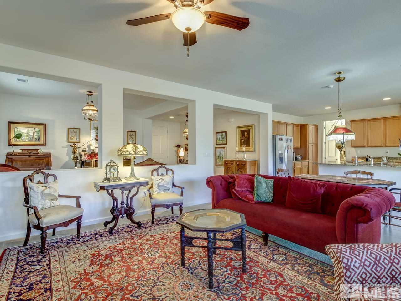 9885 Shadowless Trail Reno, NV 89521 - Photo 9 of 25 a living room with furniture potted plant and a chandelier