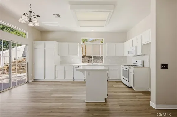 a kitchen with a sink cabinets and wooden floor