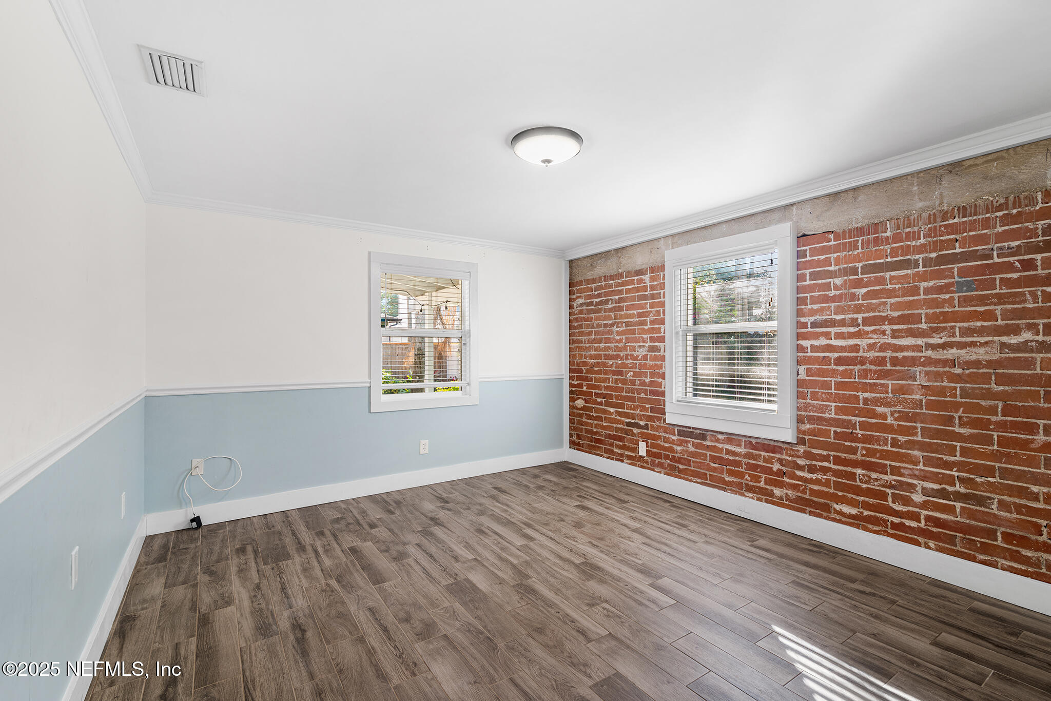 370 10th Street Atlantic Beach, FL 32233 - Photo 17 of 24 a view of an empty room with wooden floor and a window