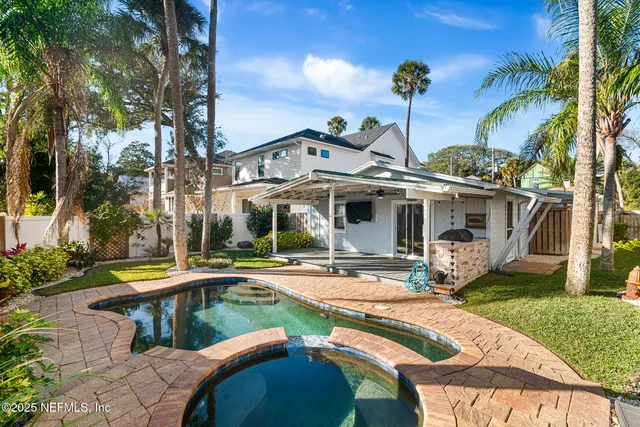 a view of a house with backyard and sitting area