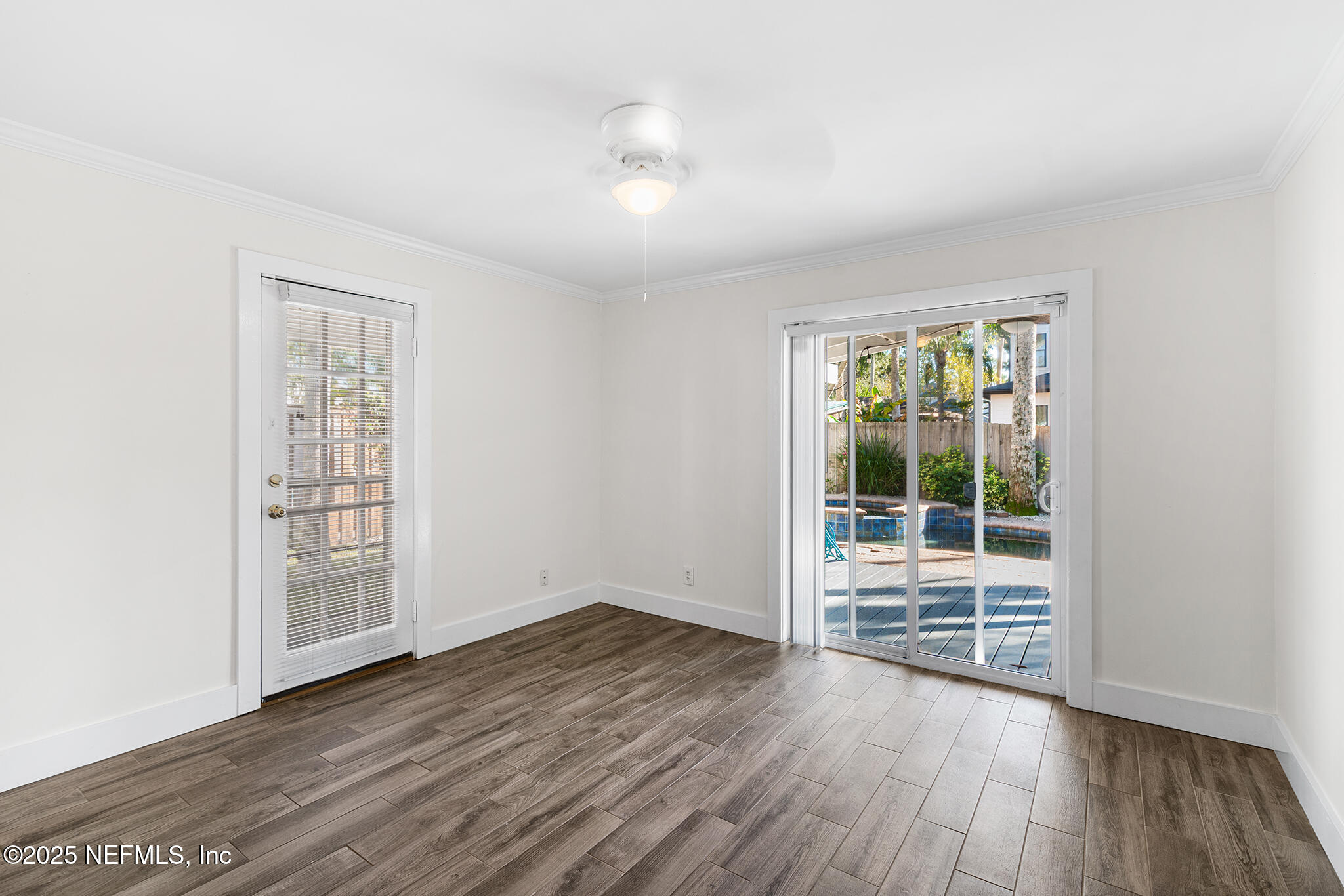 370 10th Street Atlantic Beach, FL 32233 - Photo 4 of 24 an empty room with wooden floor and windows