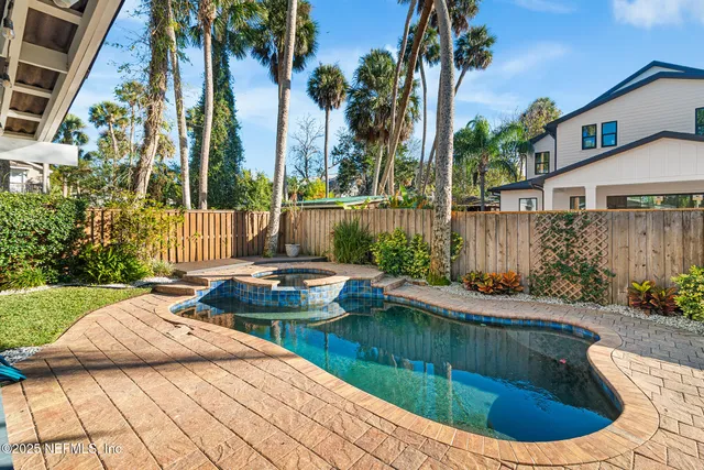 a view of a house with swimming pool and sitting area