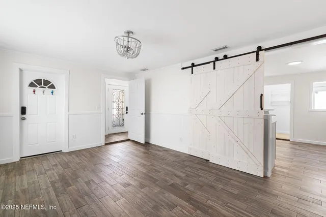 a view of an entryway with wooden floor