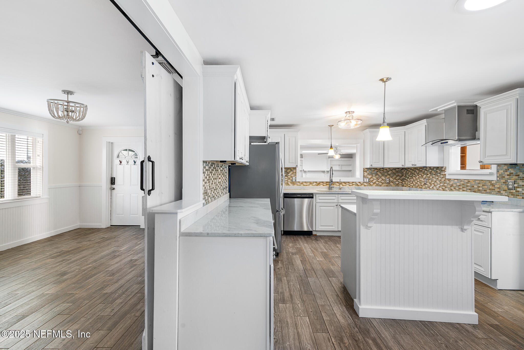 370 10th Street Atlantic Beach, FL 32233 - Photo 9 of 24 a kitchen with kitchen island a sink cabinets and wooden floor