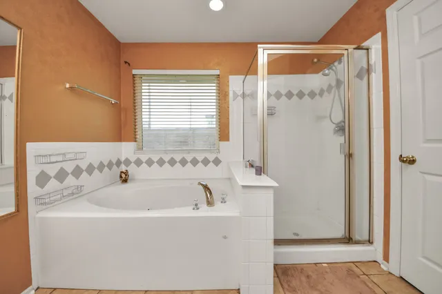 a bathroom with a bathtub and a shower