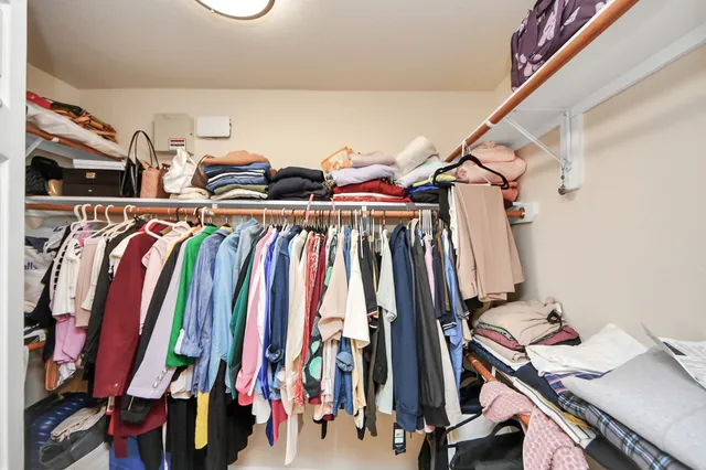 a view of walk in closet with clothes