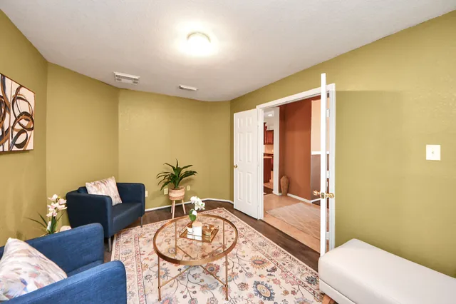 a living room with furniture and a rug
