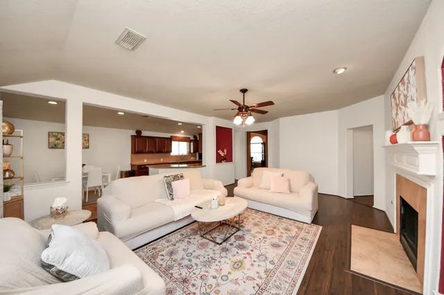 a living room with furniture fireplace and a flat screen tv