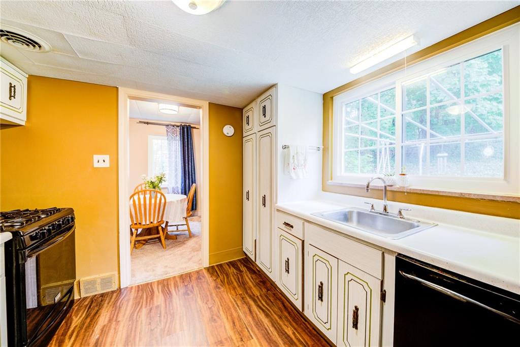 4623 Curry Road Pittsburgh, PA 15236 - Photo 22 of 25 large kitchen window is located w/ a great view of the concrete patio