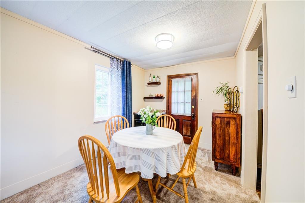 4623 Curry Road Pittsburgh, PA 15236 - Photo 8 of 25 cozy dining room area has built in cabinets- rear door leads to the awning covered concrete patio
