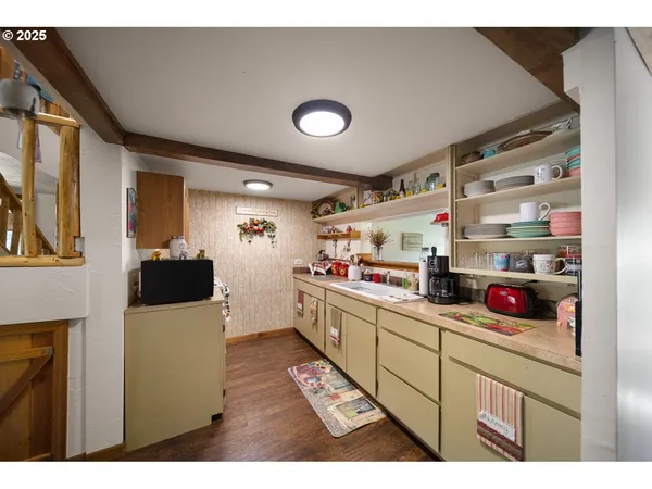 a kitchen with stainless steel appliances a microwave a stove and cabinets