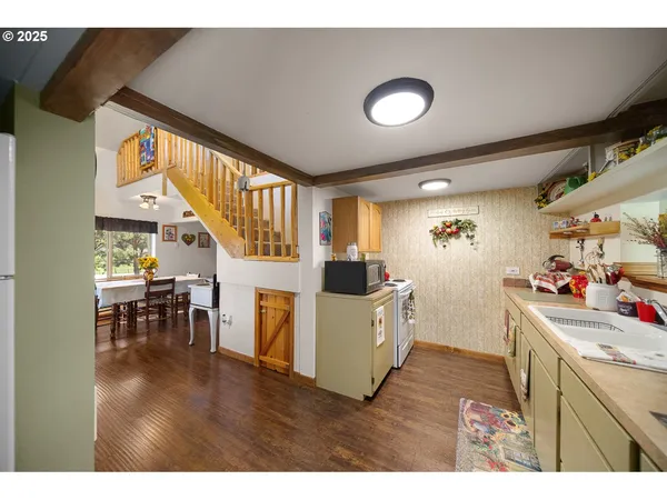 a kitchen that has a lot of cabinets a sink and a stove in it
