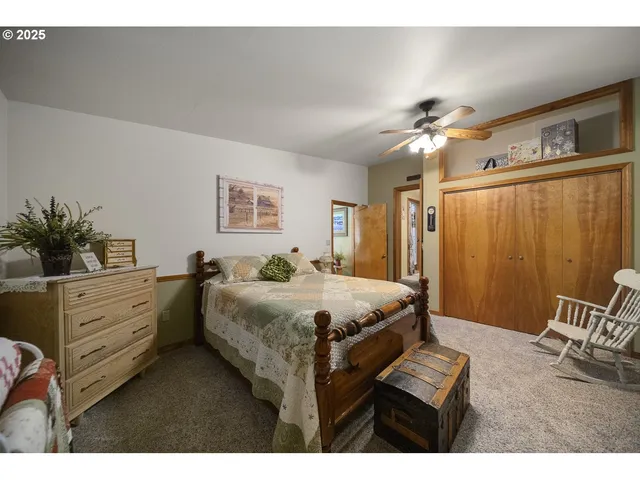 a bed room with a bed and a chair