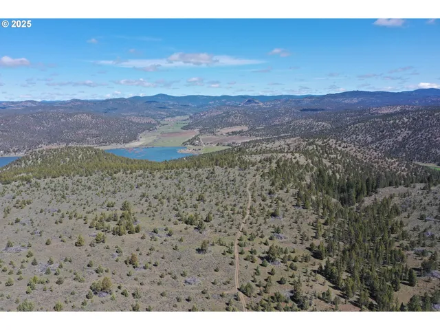a view of a yard with mountains and a ocean view