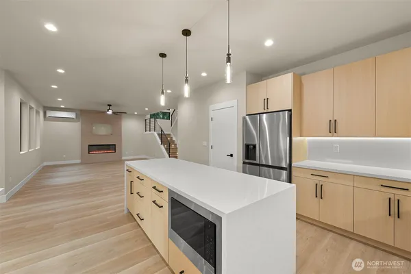 an empty room with wooden floor & closet area