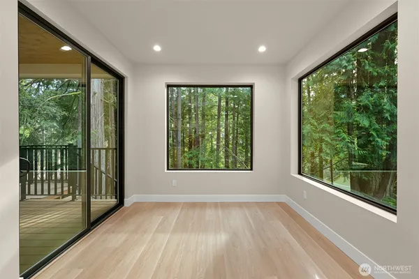 a view of an empty room with a fireplace and a window