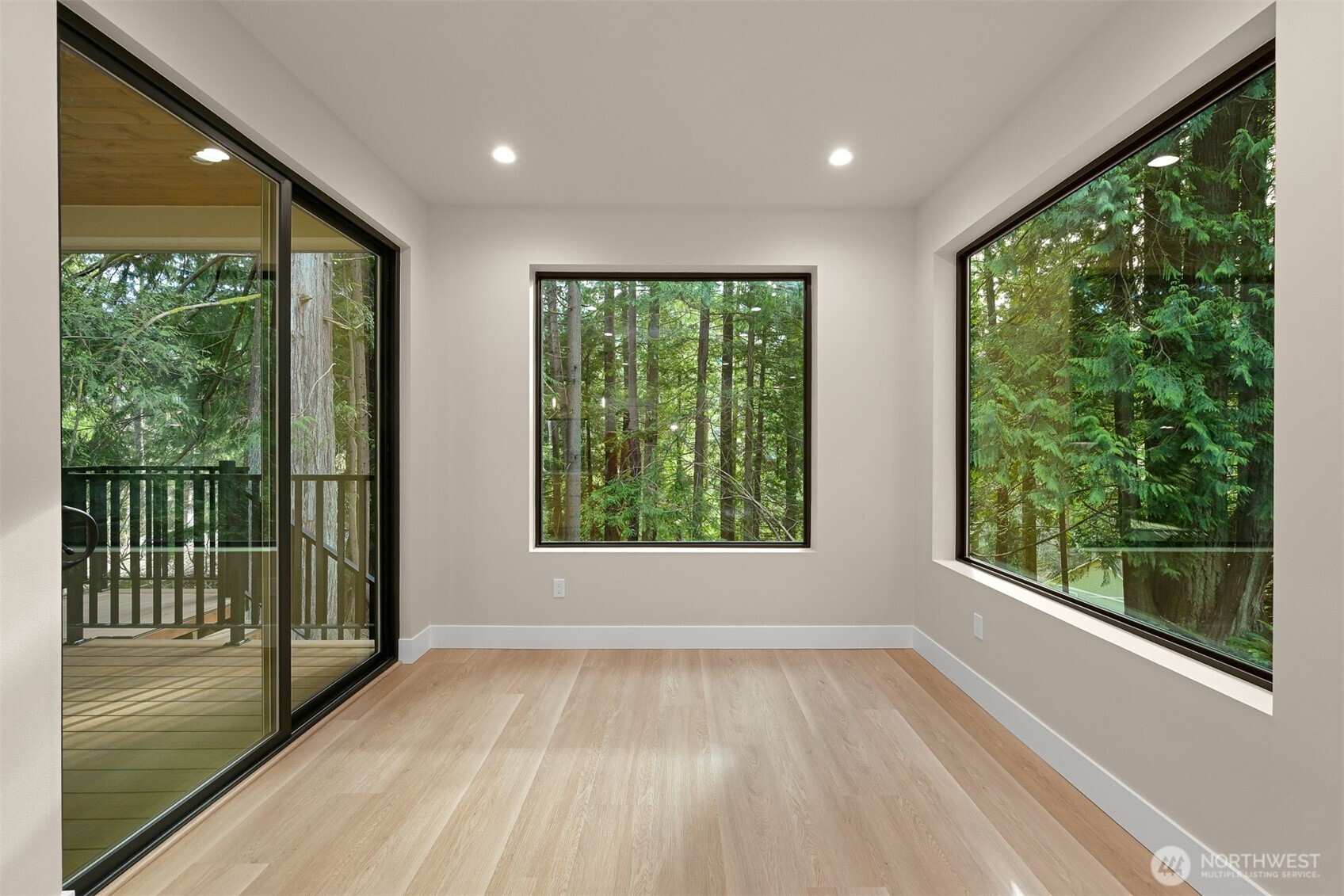 353 Sudden Valley Drive Bellingham, WA 98229 - Photo 15 of 40 a view of an empty room with wooden floor and a window