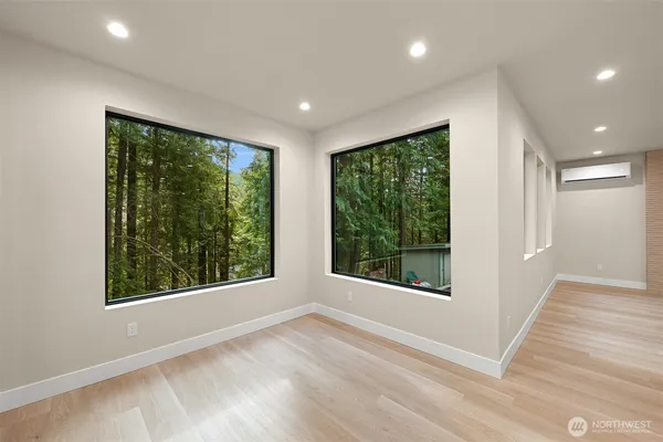 a spacious bathroom with a granite countertop sink a toilet a mirror and shower