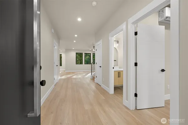 a view of a hallway with wooden floor and closet area