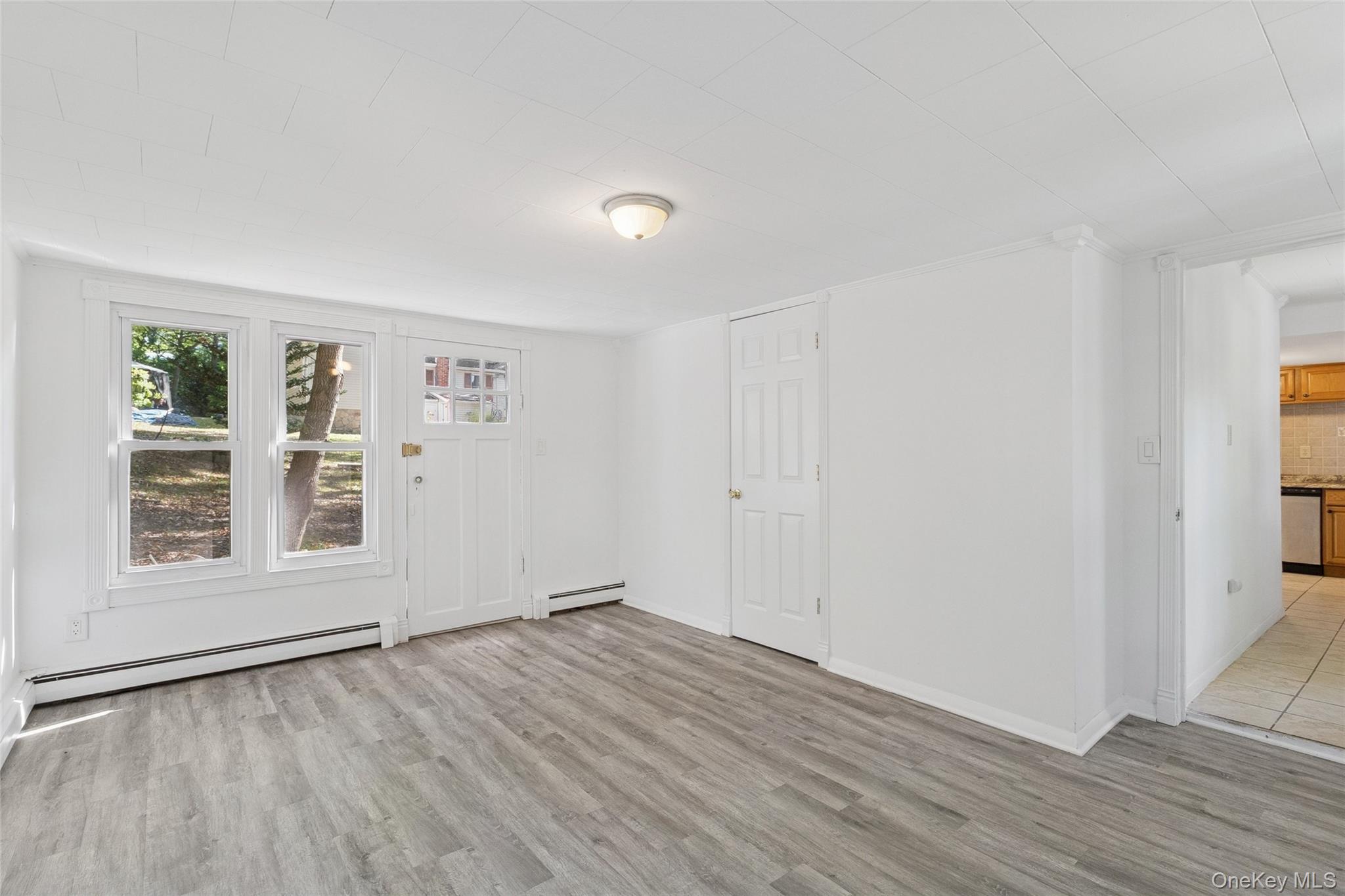 7 Yucca Road Rocky Point, NY 11778 - Photo 11 of 22 an empty room with wooden floor and windows