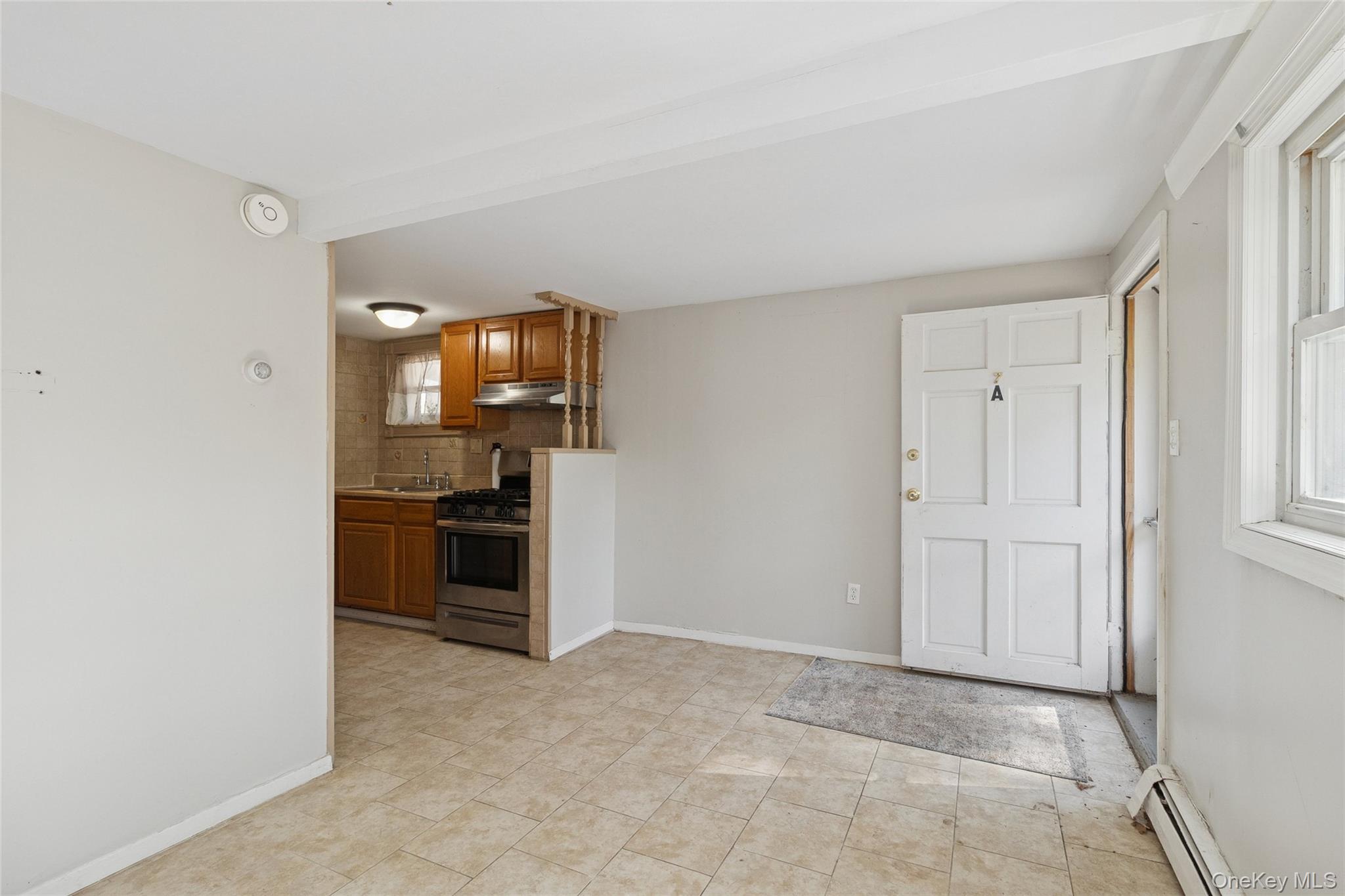 7 Yucca Road Rocky Point, NY 11778 - Photo 15 of 22 a view of a kitchen with a sink and dishwasher a refrigerator with white cabinets