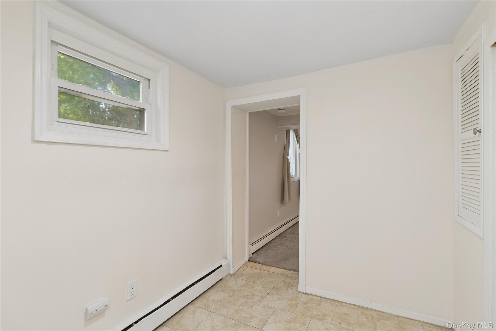 7 Yucca Road Rocky Point, NY 11778 - Photo 19 of 22 a view of an empty room with closet and a window