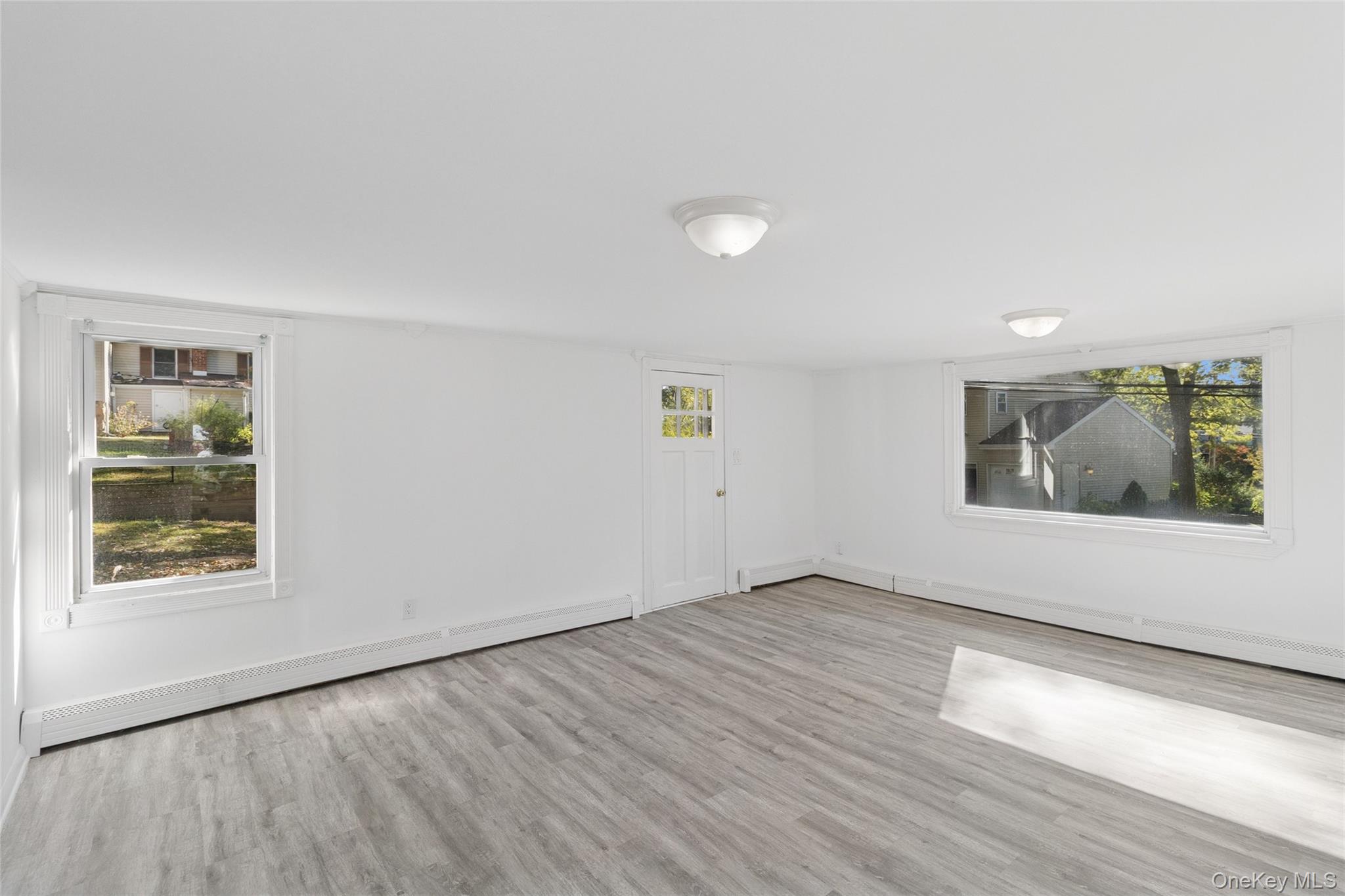 7 Yucca Road Rocky Point, NY 11778 - Photo 4 of 22 an empty room with wooden floor and windows