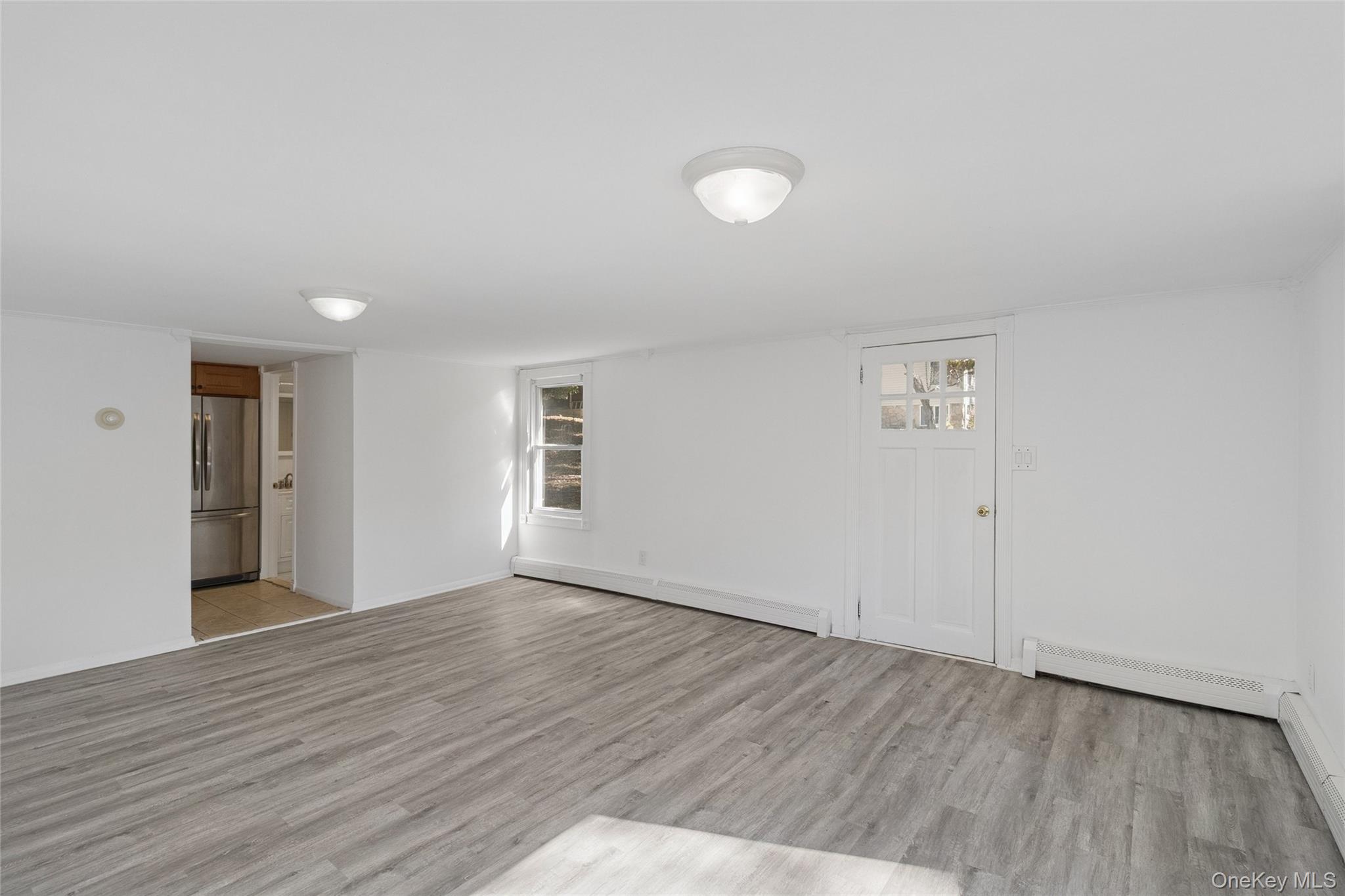 7 Yucca Road Rocky Point, NY 11778 - Photo 5 of 22 an empty room with wooden floor and windows