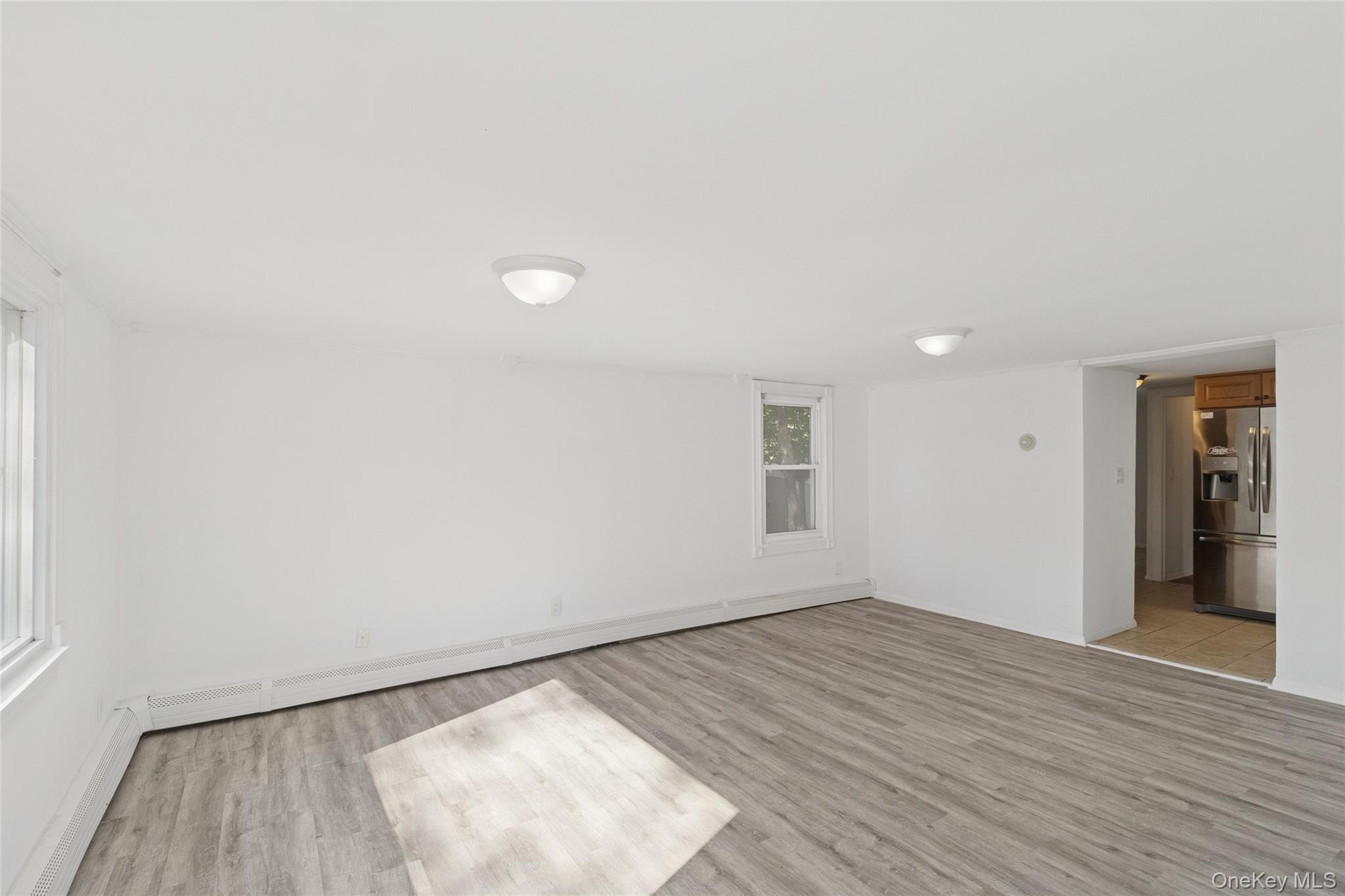 7 Yucca Road Rocky Point, NY 11778 - Photo 6 of 22 an empty room with wooden floor and windows