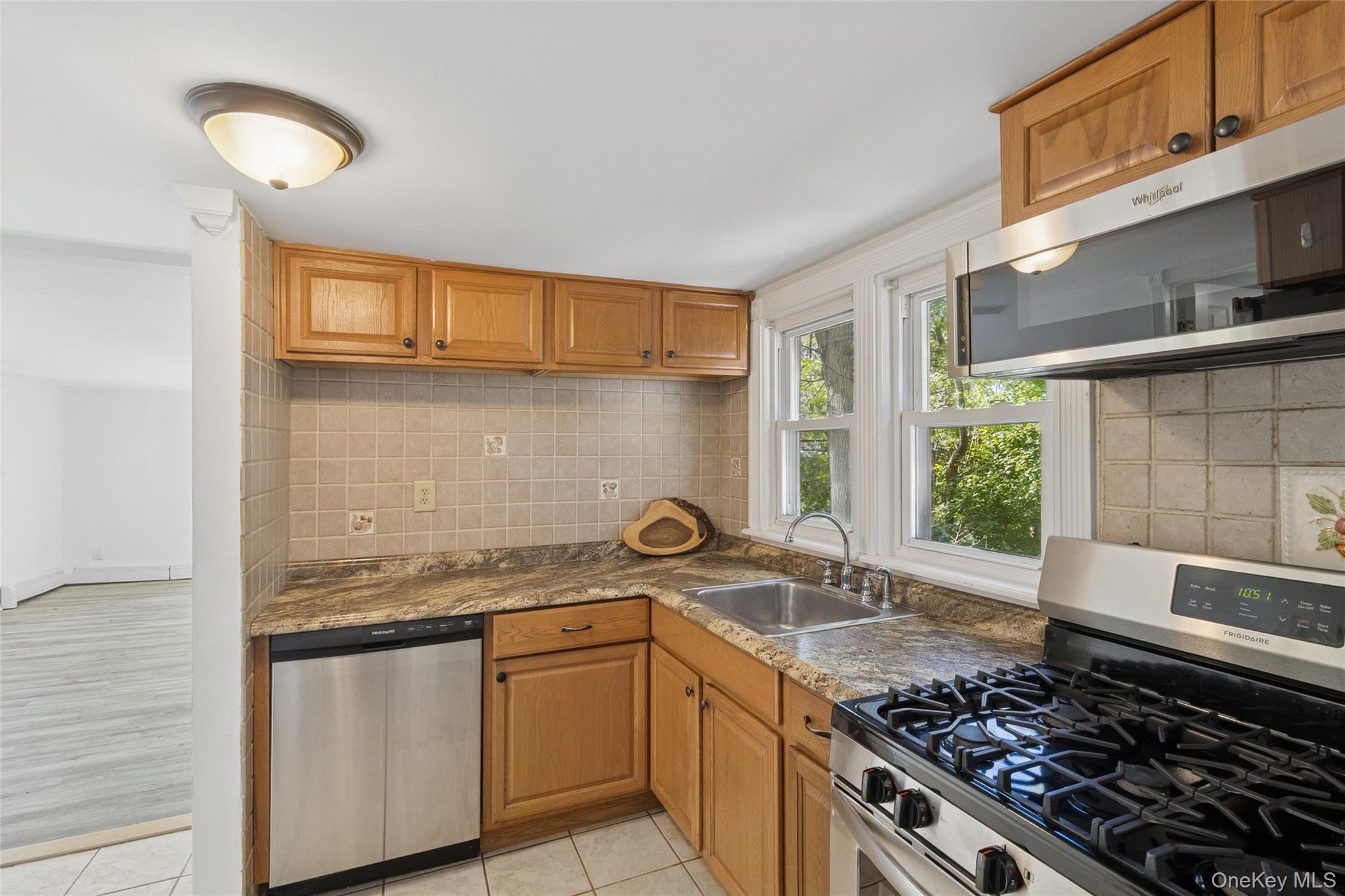 7 Yucca Road Rocky Point, NY 11778 - Photo 8 of 22 a kitchen with stainless steel appliances granite countertop a sink stove and cabinets