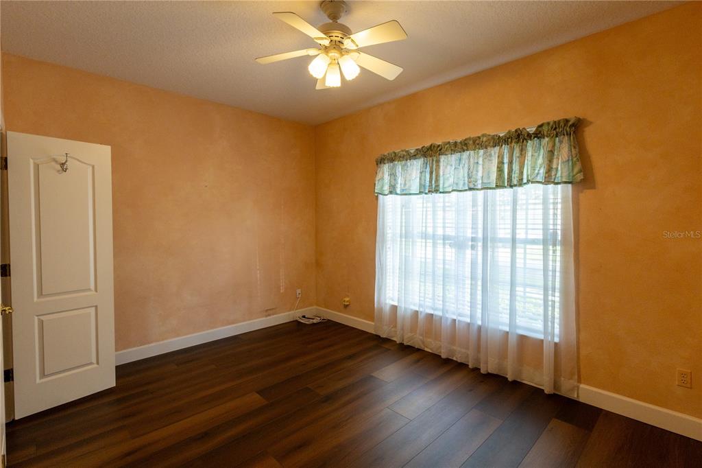 65 Calliope Street Ocoee, FL 34761 - Photo 31 of 60 a view of an empty room with wooden floor and a window