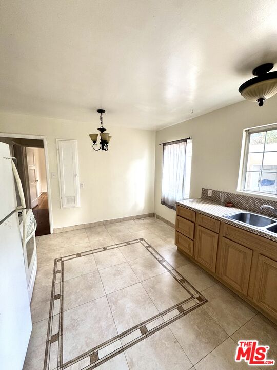 11928 Magnolia Boulevard, Unit 1/4 Valley Village, CA 91607 - Photo 7 of 9 a view of a kitchen with a sink and a window