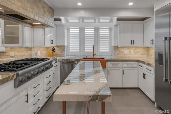 a spacious bedroom with a bed and a fireplace