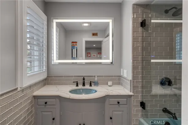 a bathroom with a toilet a sink and a window